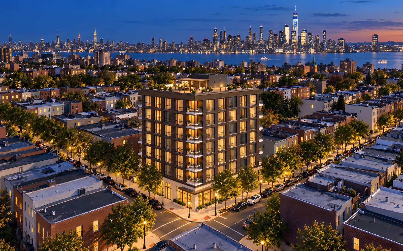 Ledgeview, a boutique residential building at night with the Manhattan skyline behind.