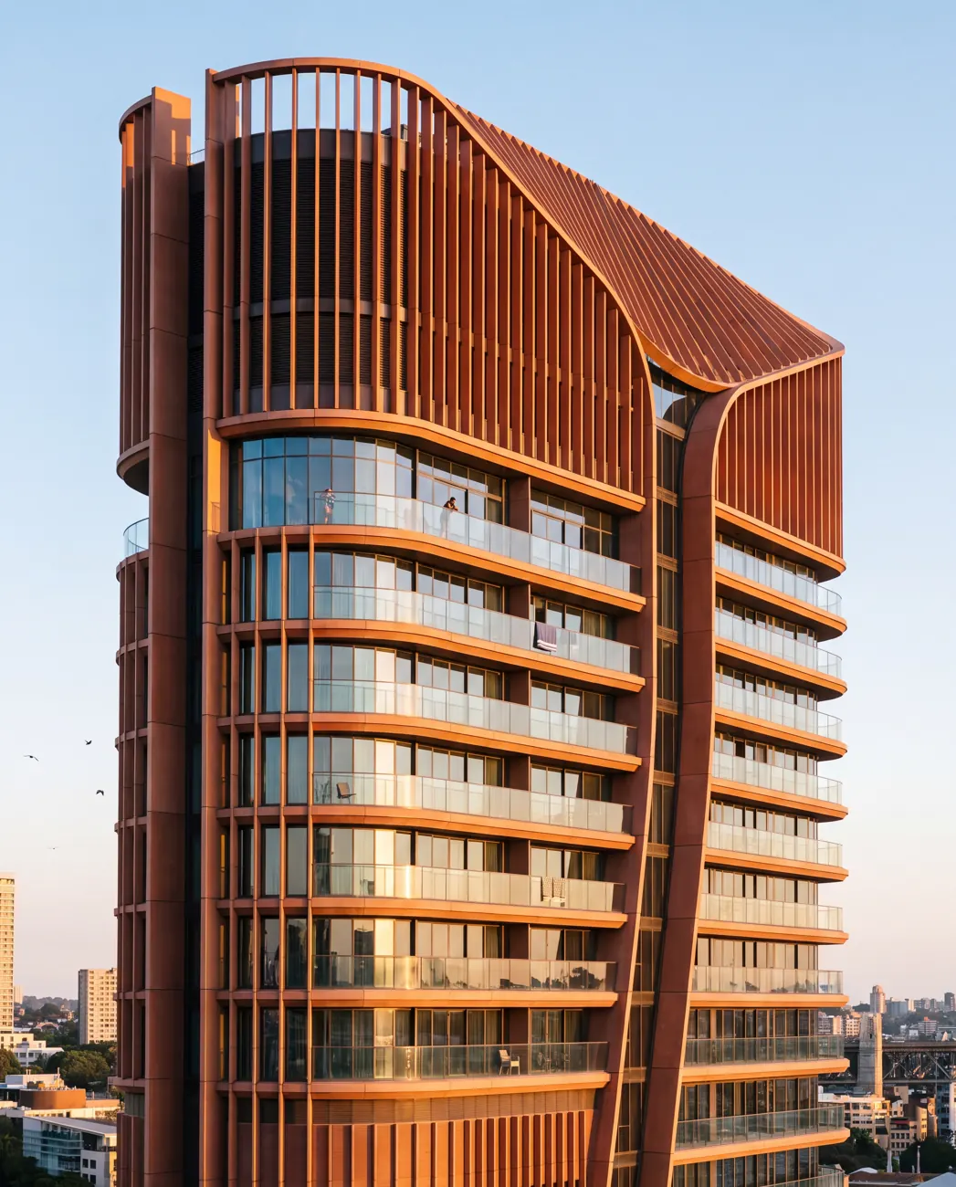 Telephoto facade detail of Barangaroo Reach: the warm terracotta vertical fins twisting slightly as they rise with curved glass balconies between them.